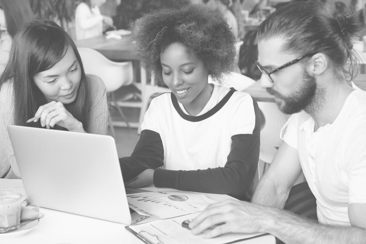 Journalists collaborating in a modern newsroom environment